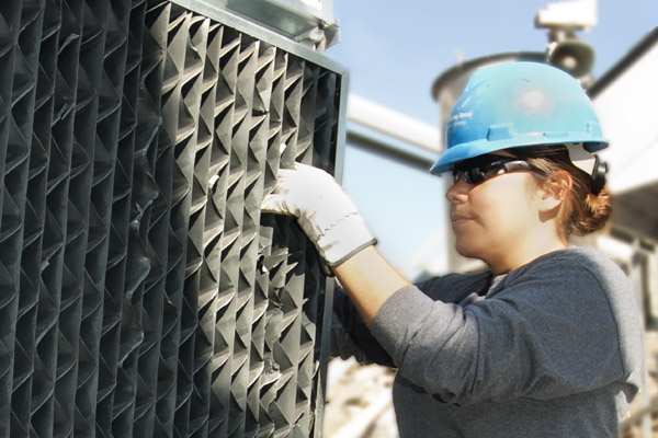 SPX About Us - Woman Inspecting HVAC Equipment